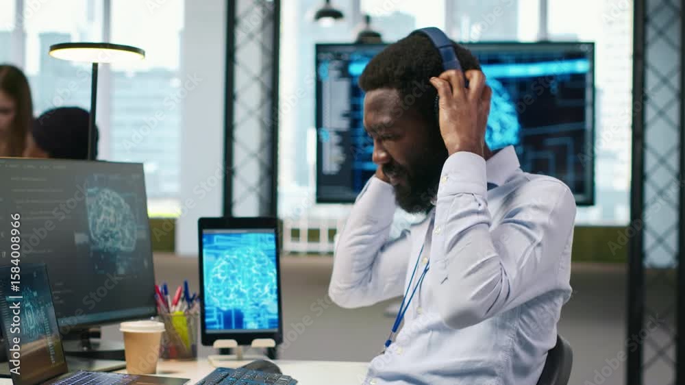 Poster system administrator at office desk developing software using ai, listening music. it expert wearing