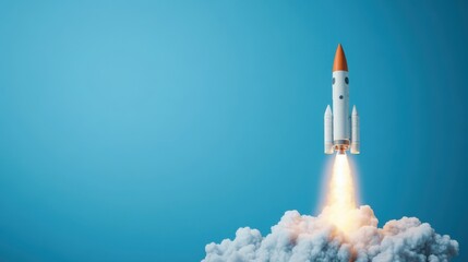 Rocket Launching into the Clear Blue Sky with Clouds Below and Flame Trail