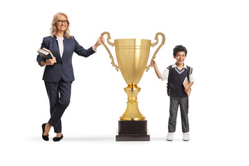 Teacher and student winning a big gold trophy cup