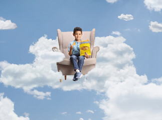 Boy eating crisps seated in an armchair