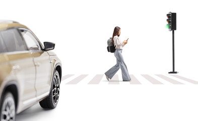 Full length profile shot of a female student walking at pedestrian zebra crossing and looking at a...