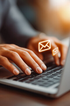 Businessman hands using Laptop typing on keyboard and surfing the internet on office table with email icon, email marketing concept, send e-mail or news letter, online working internet network..