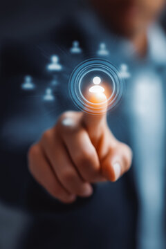 Businessman using digital interface to target customers. Marketing strategy, customer relationship management (CRM), data analytics and business growth through technology.