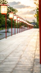 Row of red lanterns lining a stone walkway at dusk creating a warm atmosphere