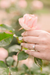 wedding ring on hand while plucking flower
