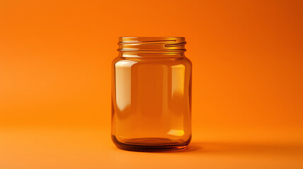 A clear empty glass jar standing against a vibrant orange backdrop, perfect for showcasing homemade products, preserves, or creative storage solutions and ideal for design mockups.