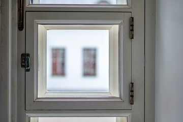 Bright and simple window frame with blurred view of a building in the background