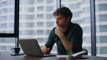 Surprised winner browsing laptop reacting emotionally on news at office closeup.
