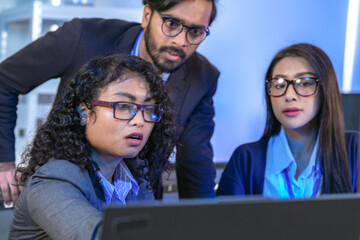 Diverse team of AI developers collaborating in a modern office. Indian male leading a discussion...