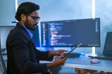 Diverse team of AI developers collaborating in a modern office. Indian male leading a discussion...