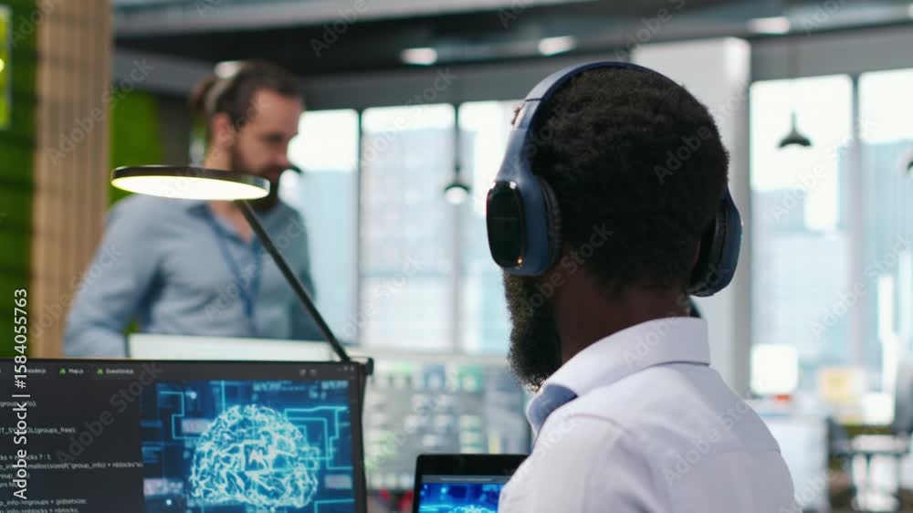 Fototapete Programmer in office relies on AI machine learning to automate repetitive tasks, looking at devices. IT expert uses neural networks artificial intelligence to speed up feature implementation, camera A