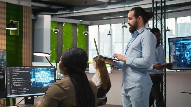 Jolly programmer coding AI algorithms on laptop to debug software issues and improving system stability. Smiling employee in tech startup office configuring settings using notebook, camera A