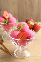 Refreshing sorbet, strawberries and mint on wooden table, closeup