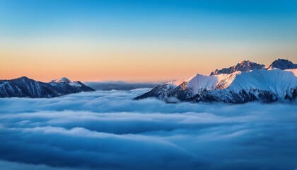 majestic snow covered mountain range under a bright blue sky with drifting clouds