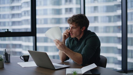 Calling executive throwing documents frustrated financial report at office.