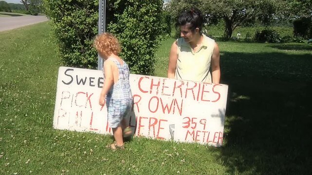 Mother and son at cherry orchard 