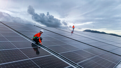 Engineers or technicians in safety gear meticulously inspecting and maintaining large-scale solar...