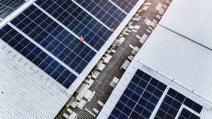 technician installs a large photovoltaic system on an industrial rooftop. ESG investment, and the...