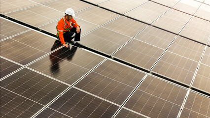 technician installs a large photovoltaic system on an industrial rooftop. ESG investment, and the...