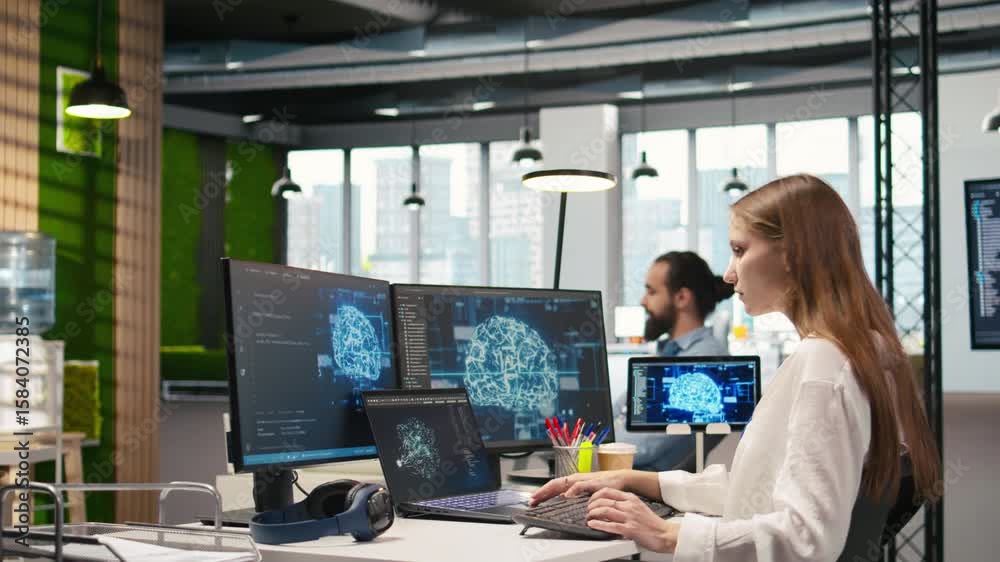  female programmer in office integrating ai machine learning systems to streamline workflows. it work