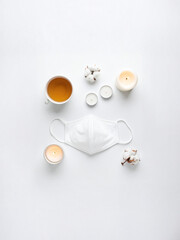 White Self-Care Flatlay with Cozy Night Tea, Candles, and Face Mask – Wellness and Relaxation Concept