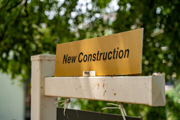 View of new construction sign in front of house.