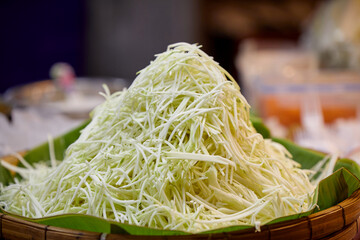 Shredded papaya for making Som Tam at street market in Thailand 