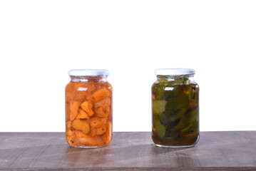 canned cashew and orange in a glass jar isolated, cashew halves in syrup, yellow fruit dessert,...