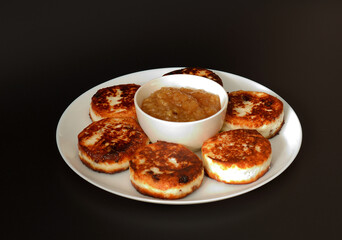 Large round plate with several fried cheesecakes stuffed with raisins and a cup of apple jam in the center on a black background.
