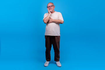 Mature Asian Male With Glasses Grimaces In Pain Holding His Cheek Due To Toothache