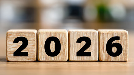Wooden blocks with bold black numbers arranged to display the year 2026, symbolizing a fresh start, future planning