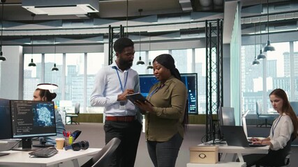Startup office coworkers doing brainstorming, developing artificial intelligence models for business analytics. Team of engineers running simulations for AI driven forecasting, camera A - Powered by Adobe