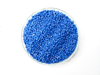 plastic masterbatch, masterbatch granules, polymer carrying pigment poured into a glass cup forming a circle with a white background, as a product catalog design for a plastic industry company profile