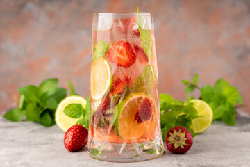 Refreshing mojito cocktail with strawberries and rum on the rustic background. Selective focus.