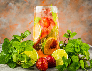 Refreshing mojito cocktail with strawberries and rum on the rustic background. Selective focus.
