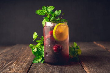 Refreshing summer cocktail with cherries and rum on the rustic background. Selective focus.