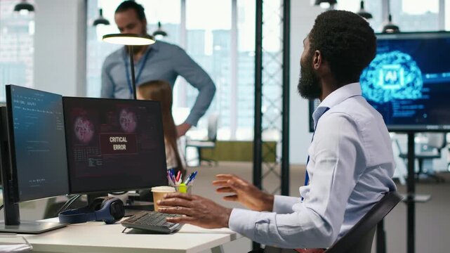 Programmer in office requesting help from coworkers to fix critical error warning. IT employee and colleagues brainstorming how to fix computer bug affecting systems, camera A