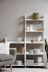Interior of living room with armchair and shelf units