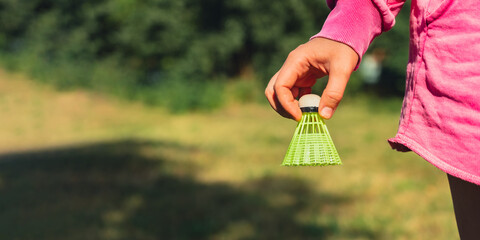 Unrecognizable woman playing with Wooden badminton rackets and shuttlecocks soft focus concept....