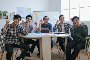 Collaborative Group Celebrating Milestone Around Table