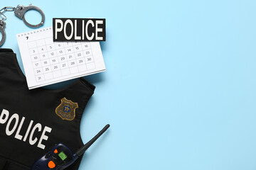 Calendar with policeman's items on blue background