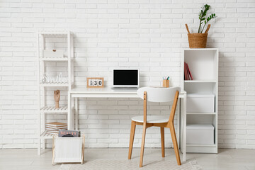 Interior of office with workplace and shelf units