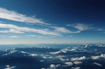 Fototapeta premium Crisp clear winter sky shaded in deep blue tones fading to pale horizon accented with thin high-altitude clouds stretching across frame creating cold atmospheric seasonal capture with