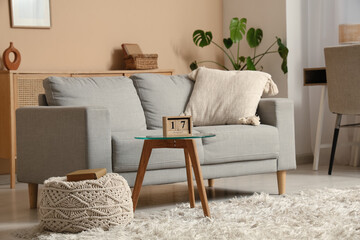 Interior of living room with sofa and cube calendar on table