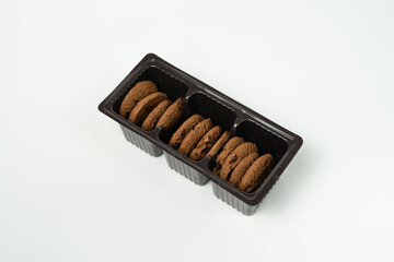 chocolate cookies in plastic box isolated background
