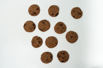 Pile of Delicious Chocolate Cookies with Chocolate Chips on White Background
