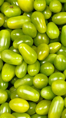 Fresh tomatoes on a shelf in a supermarket. Close-up photo of fruits and vegetables for cooking.