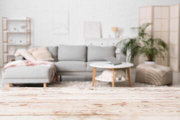 Empty white wooden table against blurred living room interior
