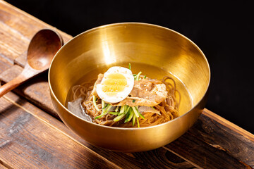 Korean Mul Naengmyeon (Cold Buckwheat Noodles in Icy Broth) – Traditional Korean Summer Dish with Tangy Chilled Soup, Sliced Beef, Cucumber, Egg, and Mustard, Served in a Stainless Bowl
