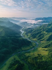 Fototapeta premium Misty mountain valley with winding river